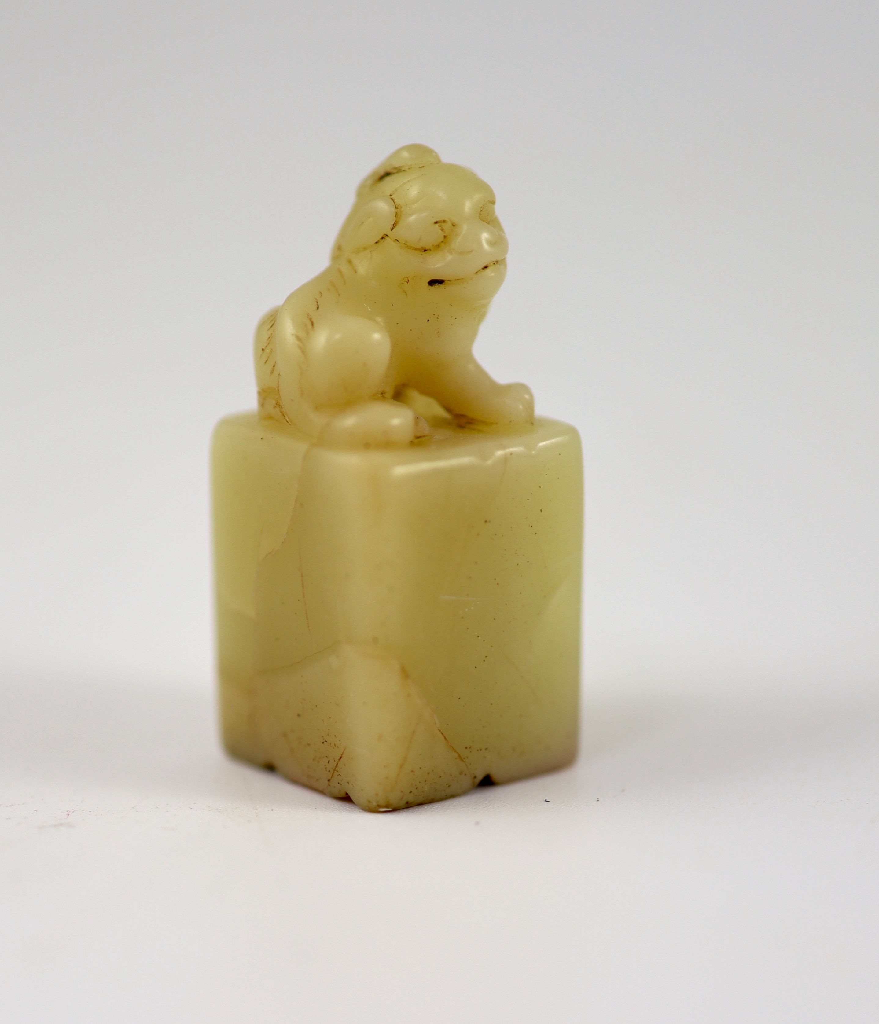 A Chinese inscribed cream coloured soapstone seal, 3.9 cm high